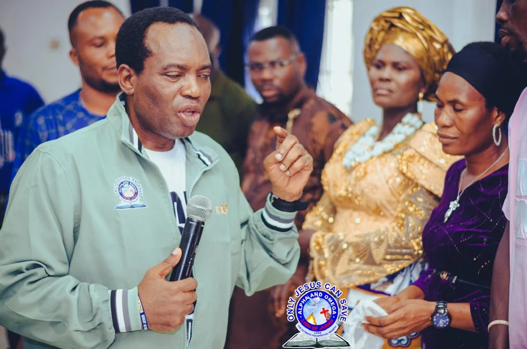 Pastor stretching hands in prayer and blessing over the people