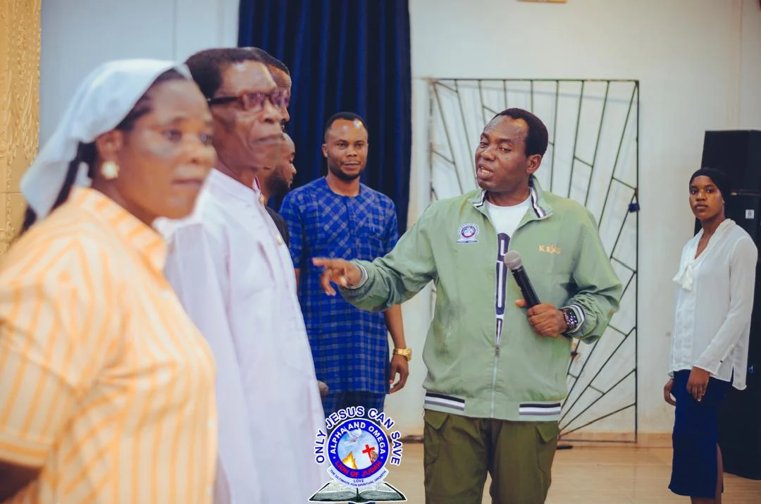 Pst. Akpos ministering at the altar with church members and elders in golden attire