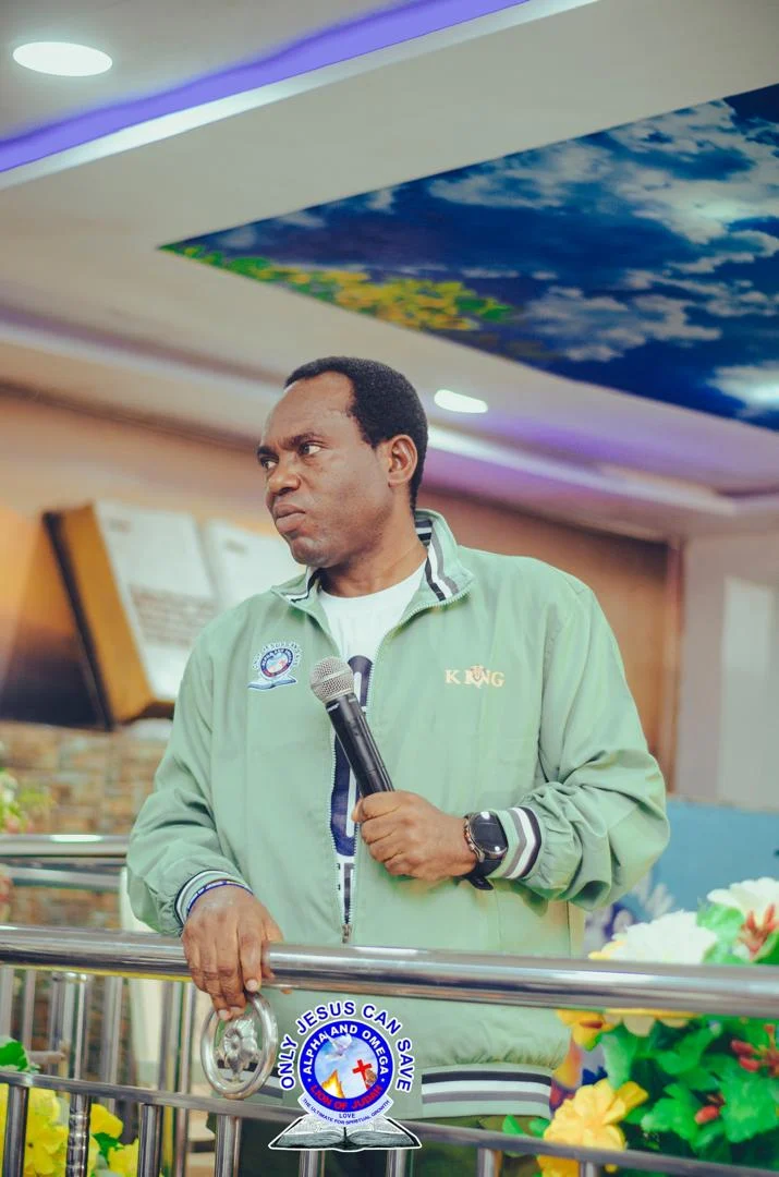 Pastor Akpos in deep reverent prayer at the altar